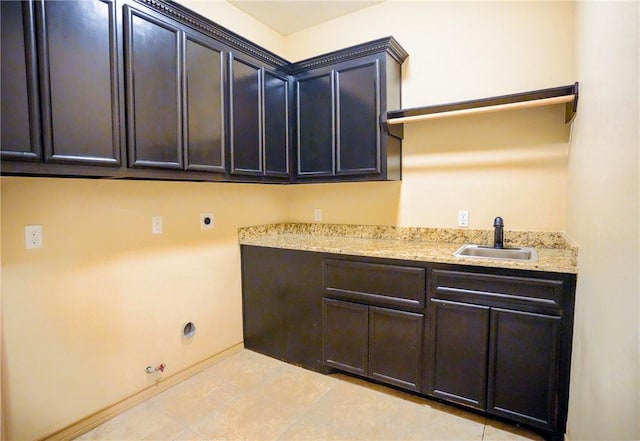 6725 Brooke Rd, Corpus Christi, TX 78414 - washroom featuring cabinet space, hookup for a gas dryer, electric dryer hookup, and light tile patterned floors