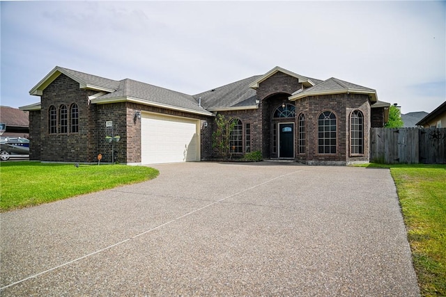 6725 Brooke Rd, Corpus Christi, TX 78414 - french provincial home with brick siding, a garage, driveway, and roof with shingles