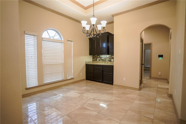 6725 Brooke Rd, Corpus Christi, TX 78414 - kitchen with arched walkways, tasteful backsplash, ornamental molding, a chandelier, and a raised ceiling