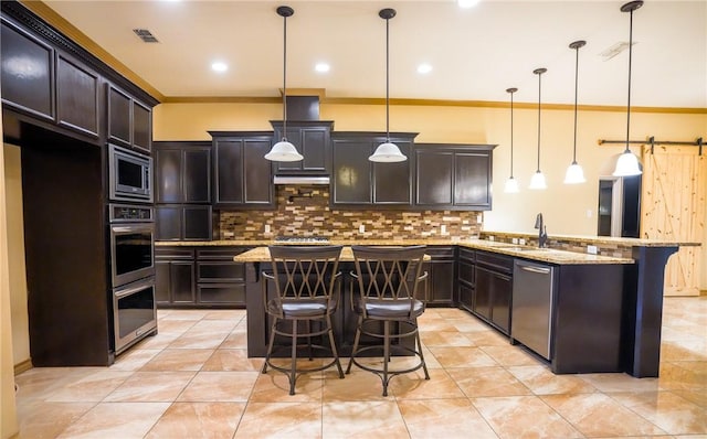 6725 Brooke Rd, Corpus Christi, TX 78414 - kitchen with appliances with stainless steel finishes, a breakfast bar area, a peninsula, backsplash, and light stone counters