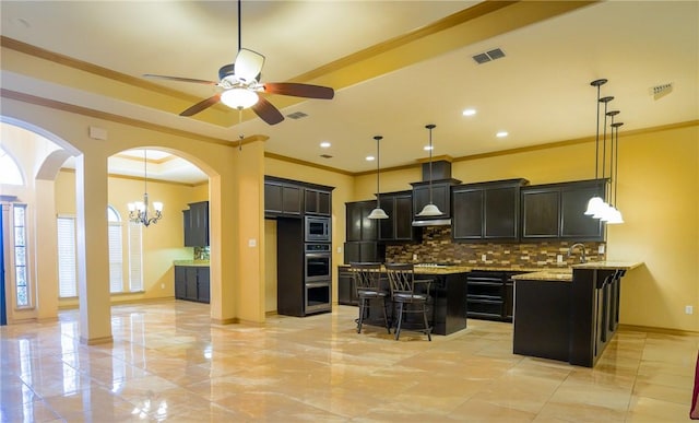 6725 Brooke Rd, Corpus Christi, TX 78414 - kitchen featuring appliances with stainless steel finishes, a kitchen breakfast bar, tasteful backsplash, crown molding, and ceiling fan