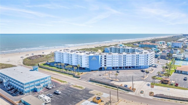 birds eye view of property featuring a water view, a view of the beach, and a city view