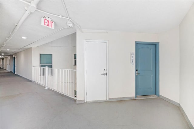 interior space with concrete floors and baseboards