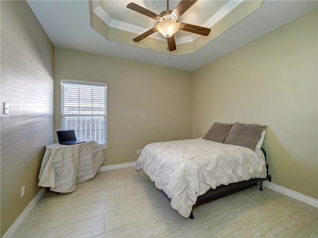 bedroom featuring ceiling fan, a raised ceiling, and ornamental molding