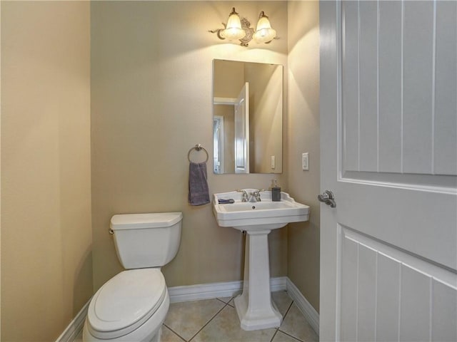 bathroom featuring tile patterned flooring, toilet, and sink