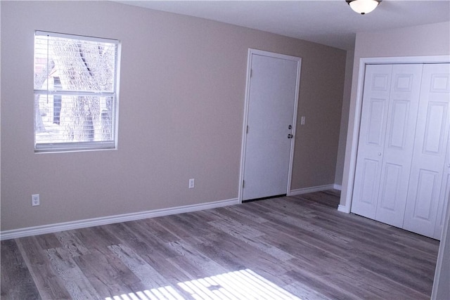 unfurnished bedroom with hardwood / wood-style flooring and a closet