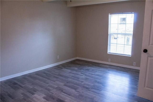 empty room with dark wood-type flooring