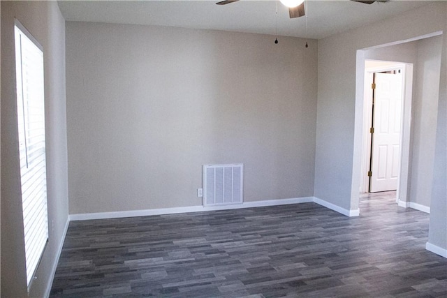 spare room with dark hardwood / wood-style floors and a wealth of natural light