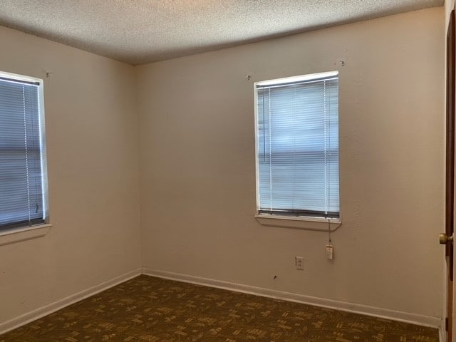 empty room featuring a textured ceiling