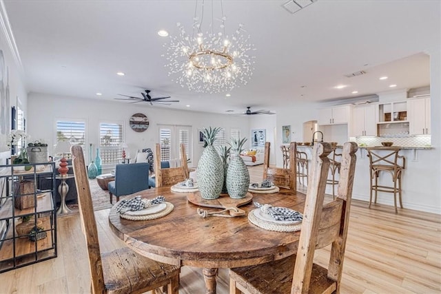 dining area featuring light wood finished floors, visible vents, and recessed lighting