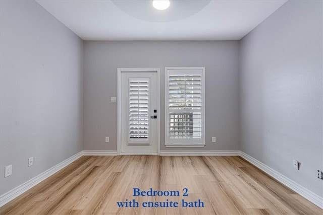 spare room with light wood-style flooring and baseboards