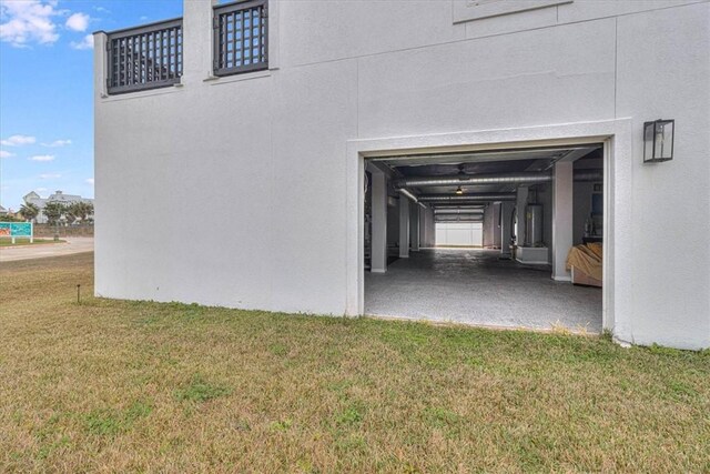 exterior space with a lawn and stucco siding