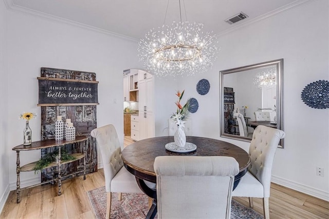 dining area featuring light wood finished floors, visible vents, arched walkways, and crown molding