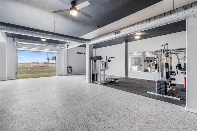 workout area with a ceiling fan and baseboards