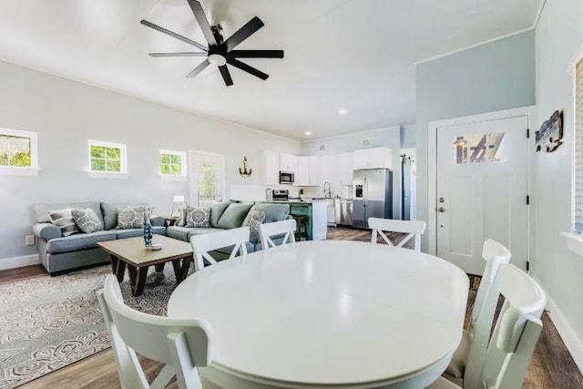 dining area featuring ceiling fan, baseboards, wood finished floors, and recessed lighting