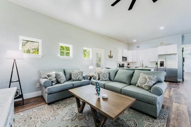 living area featuring recessed lighting, visible vents, a ceiling fan, wood finished floors, and baseboards