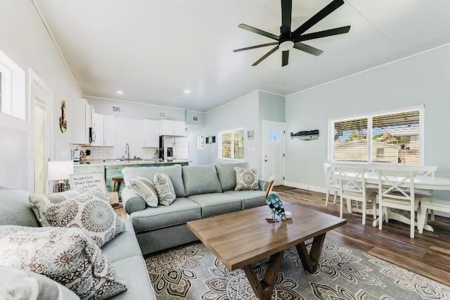 living area with ceiling fan, recessed lighting, wood finished floors, baseboards, and crown molding