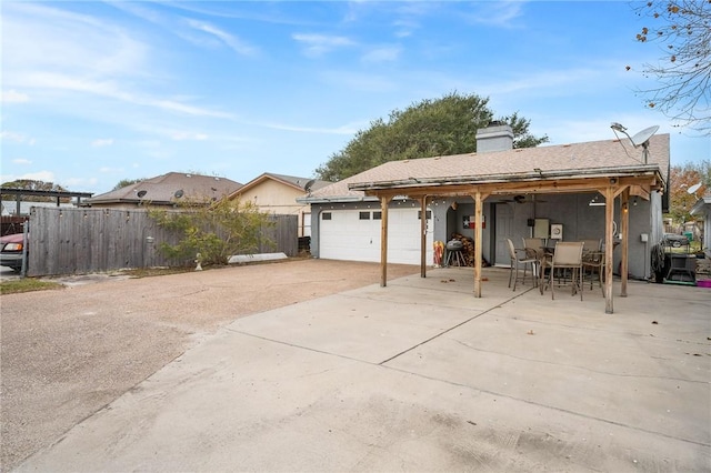 back of house featuring a patio and a garage