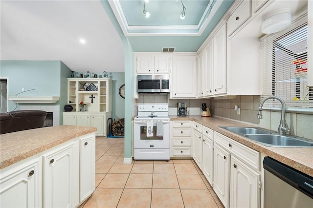 kitchen featuring stainless steel appliances, tasteful backsplash, light tile patterned flooring, white cabinets, and sink