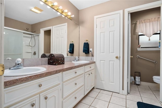 bathroom featuring walk in shower, vanity, tile patterned flooring, and toilet