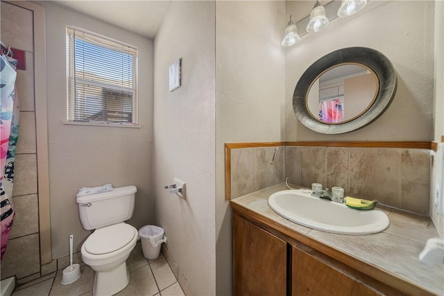 bathroom featuring tile patterned flooring, vanity, and toilet