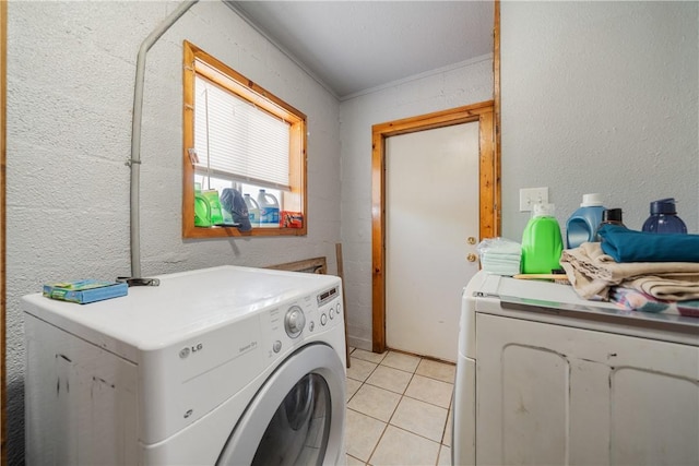 clothes washing area with light tile patterned floors and separate washer and dryer