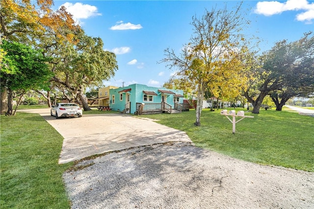 view of front of home featuring a deck and a front lawn