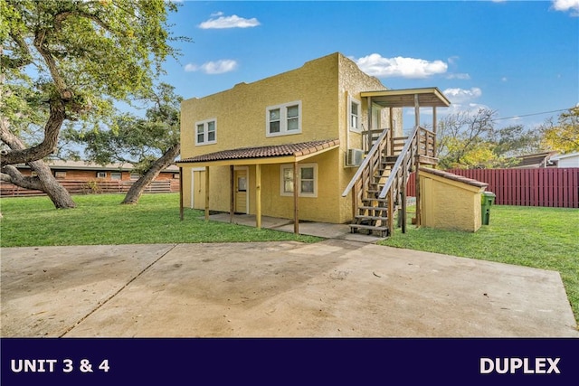 rear view of property featuring a yard and a patio