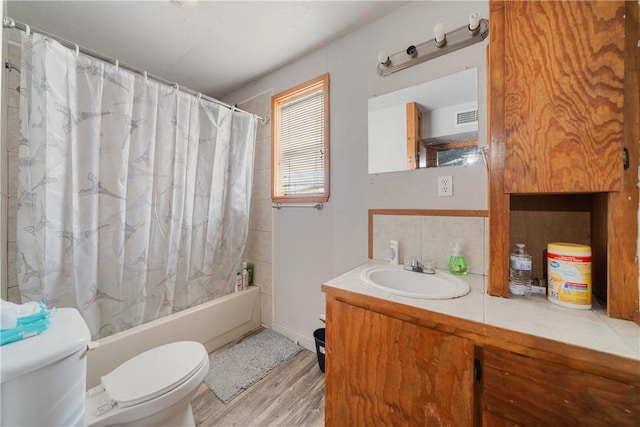 full bathroom featuring wood-type flooring, vanity, toilet, and shower / bath combination with curtain