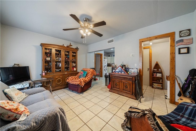 tiled living room with ceiling fan