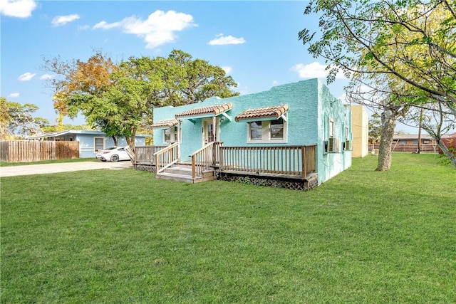 view of front of home featuring a deck and a front yard