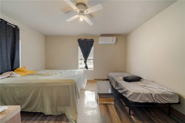 bedroom with an AC wall unit and ceiling fan