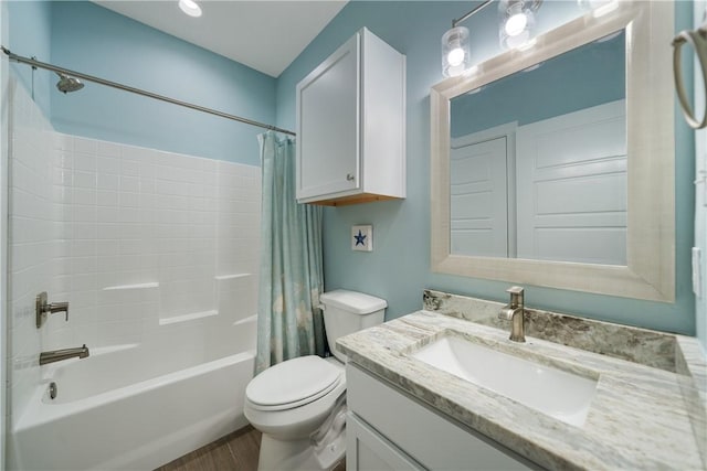 bathroom with toilet, wood finished floors, vanity, and shower / bath combination with curtain