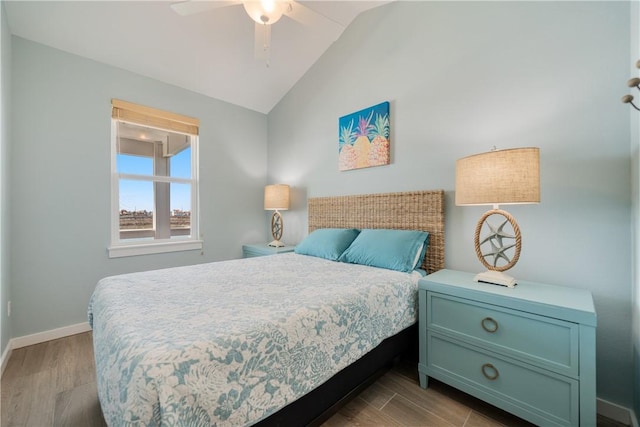 bedroom with ceiling fan, baseboards, lofted ceiling, and wood finished floors