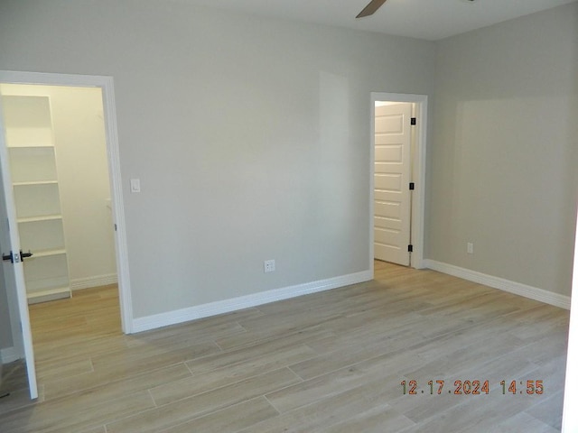 spare room with ceiling fan and light hardwood / wood-style flooring