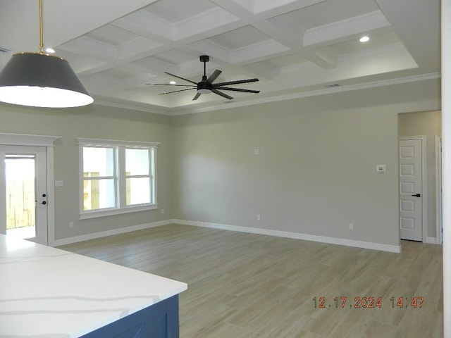 interior space featuring ceiling fan, light hardwood / wood-style floors, ornamental molding, and coffered ceiling