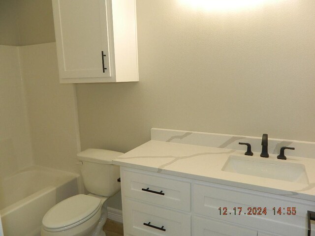 bathroom featuring toilet and vanity