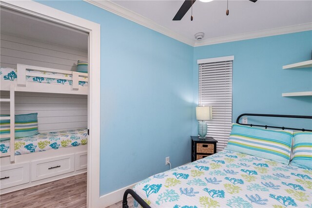 bedroom featuring hardwood / wood-style floors, ceiling fan, and crown molding