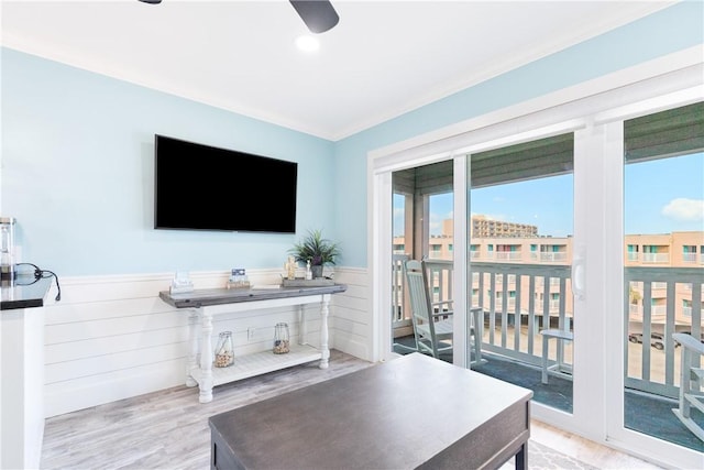 3938 Surfside Blvd Unit 1319, Corpus Christi, TX 78402 - living area with wood finished floors, a ceiling fan, a wainscoted wall, and crown molding
