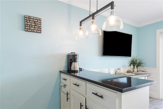 bar featuring light hardwood / wood-style flooring, decorative light fixtures, crown molding, and white cabinets