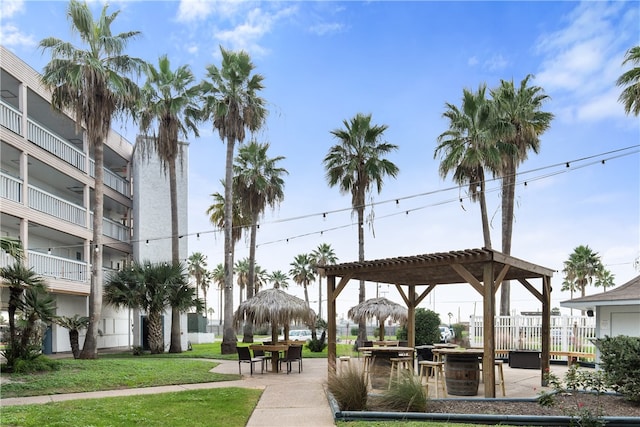 view of property's community with a lawn and a patio