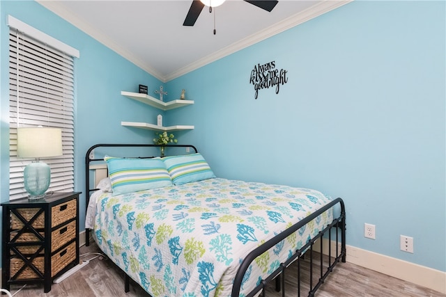 bedroom with wood-type flooring, vaulted ceiling, ceiling fan, and crown molding