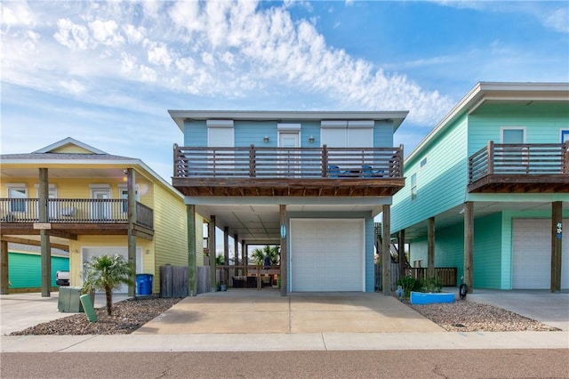 view of front of property featuring a garage, a carport, concrete driveway, and a balcony