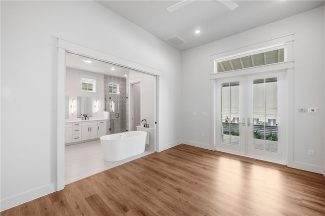 foyer entrance with wood-type flooring and french doors