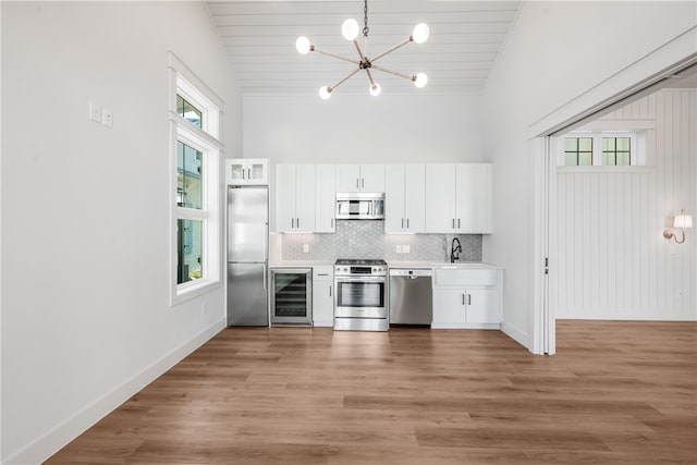 kitchen featuring plenty of natural light, white cabinets, and stainless steel appliances