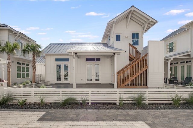 rear view of house featuring french doors