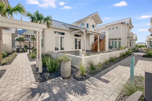 rear view of house featuring french doors