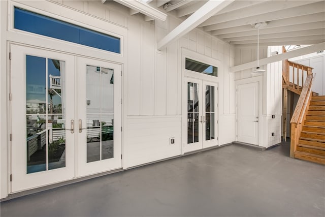 view of exterior entry with french doors and a patio area