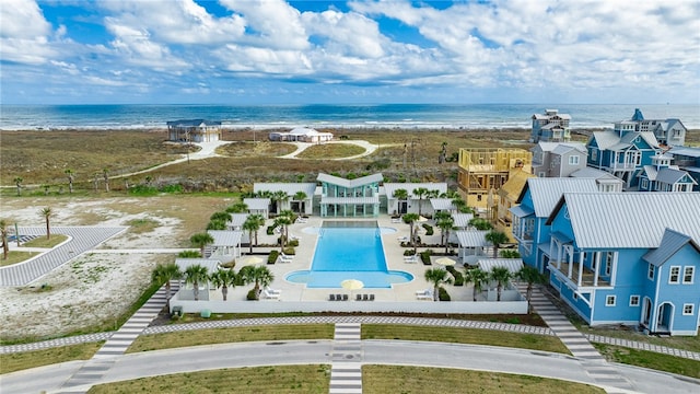 birds eye view of property featuring a view of the beach and a water view