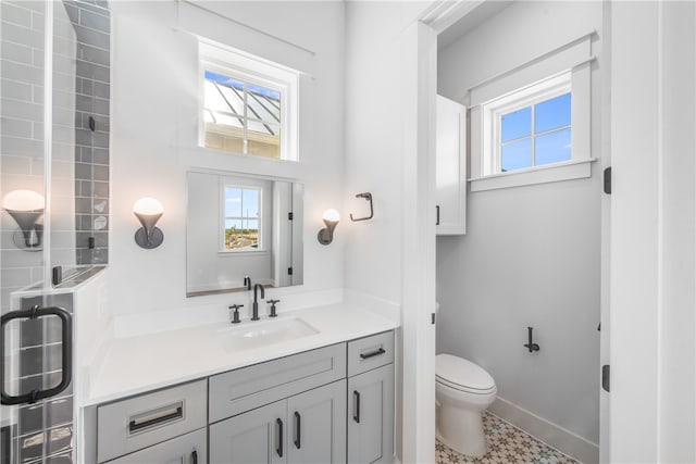 bathroom with tile patterned floors, vanity, and toilet